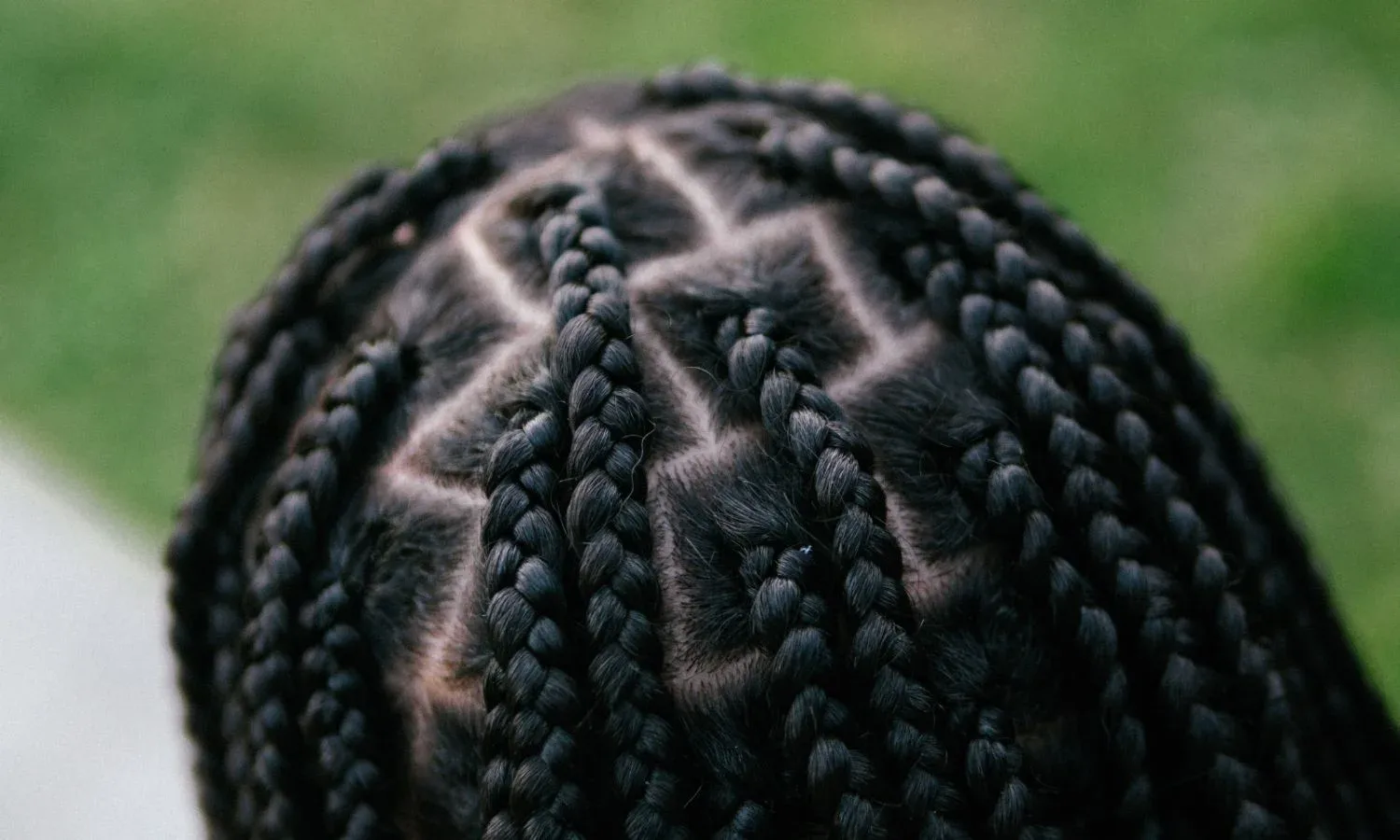 close up of braids showing scalp tension from tight braids and braid bumps