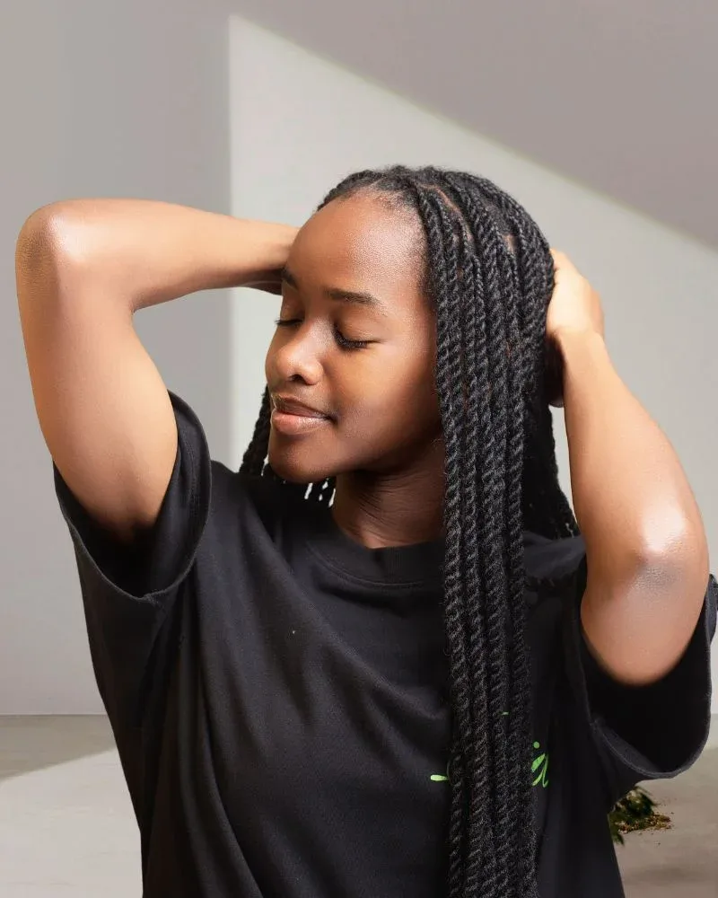 Woman wearing long two-strand twists as a protective hairstyle.