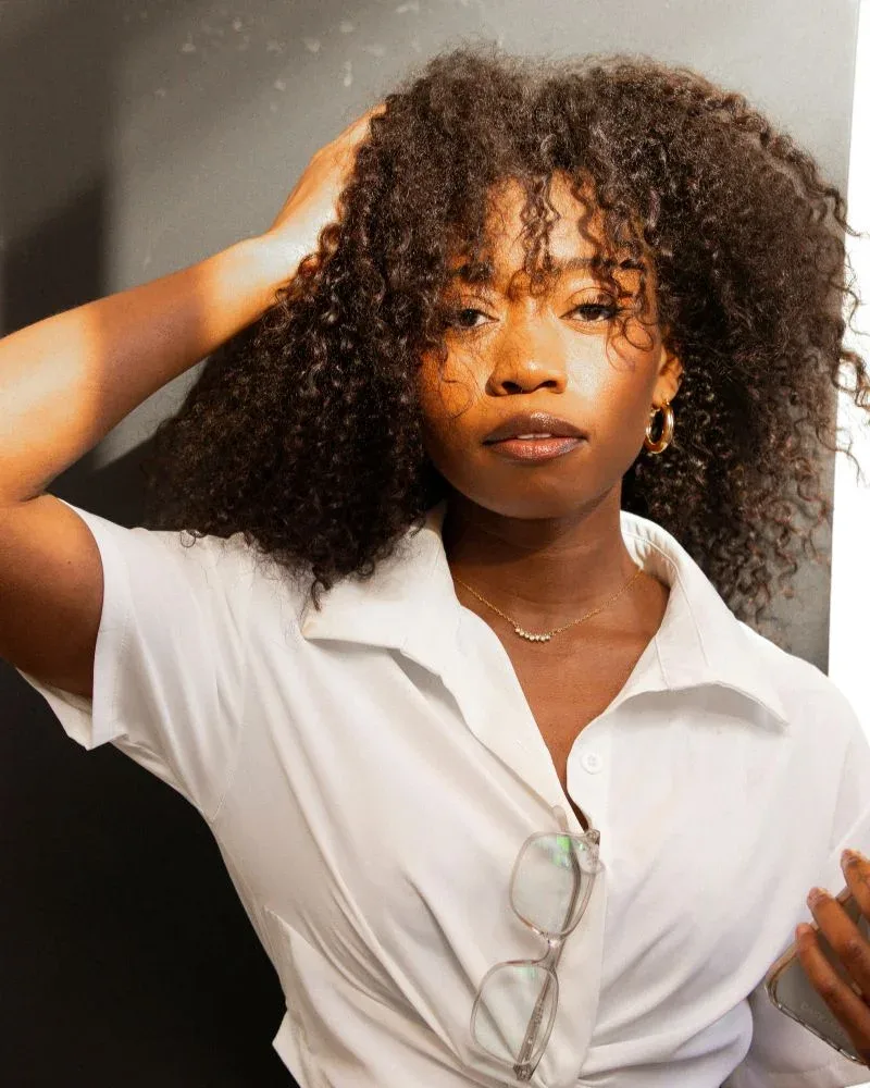Curly natural hair appearing weighed down from product buildup