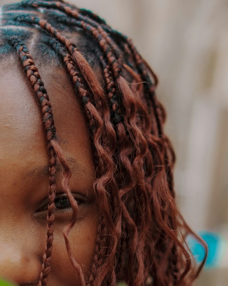 Scalp buildup visible around braided natural hair roots