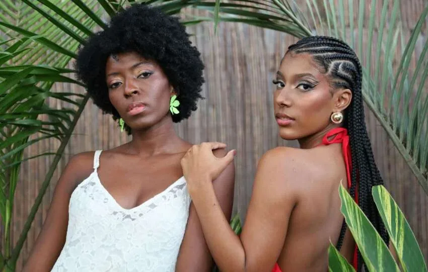 Woman with natural afro beside woman wearing cornrows, showing low-manipulation hairstyles for a 4C hair routine