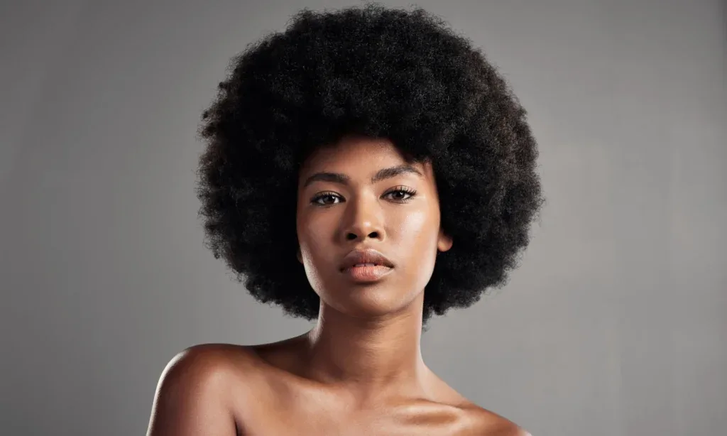 Woman with fine 4C hair smiling for a guide to the best 4C hair products