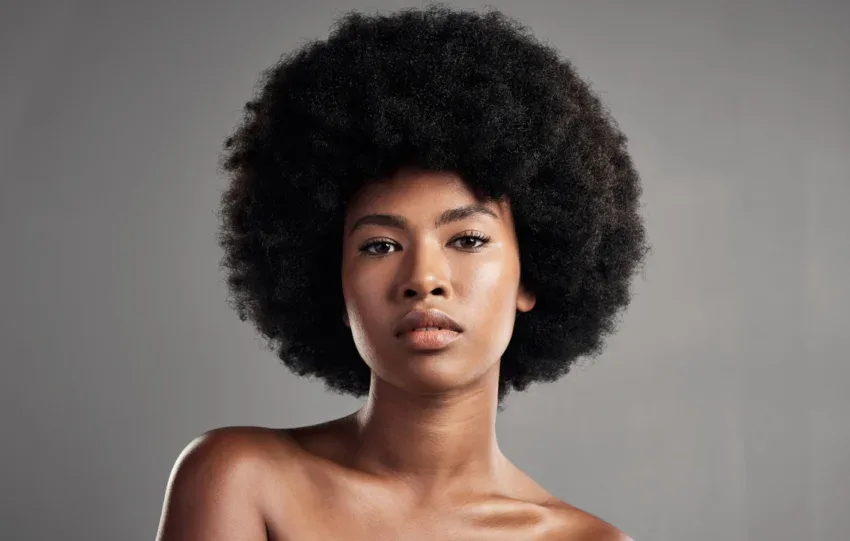 Woman with fine 4C hair smiling for a guide to the best 4C hair products