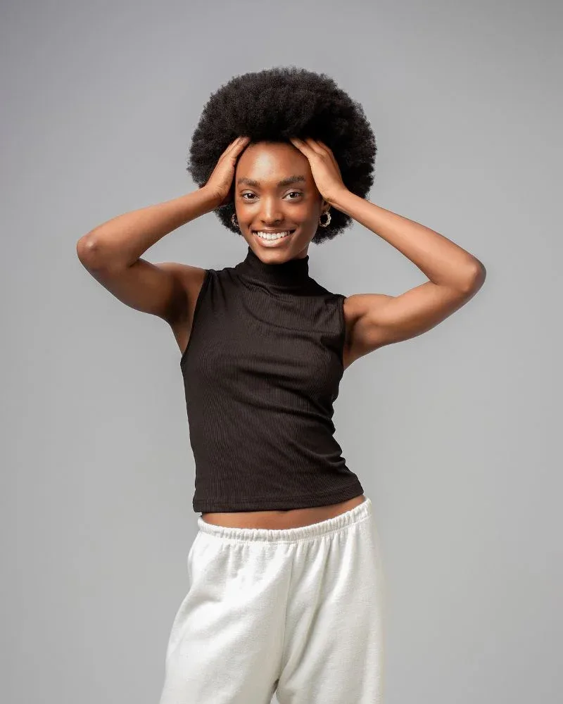Woman fluffing her fine 4C afro with her hands